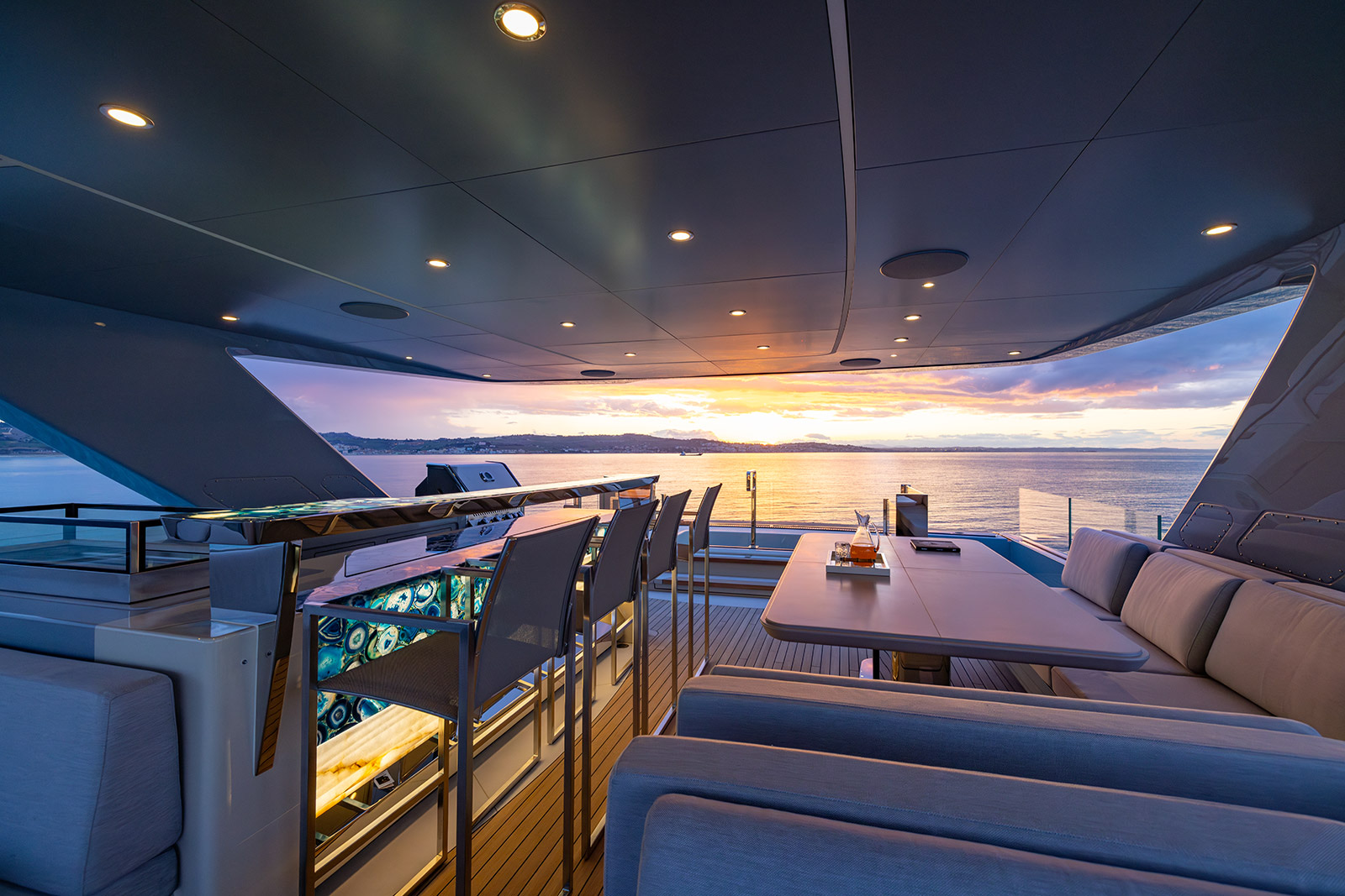Pazienza sundeck dining area with panoramic sunset over the ocean